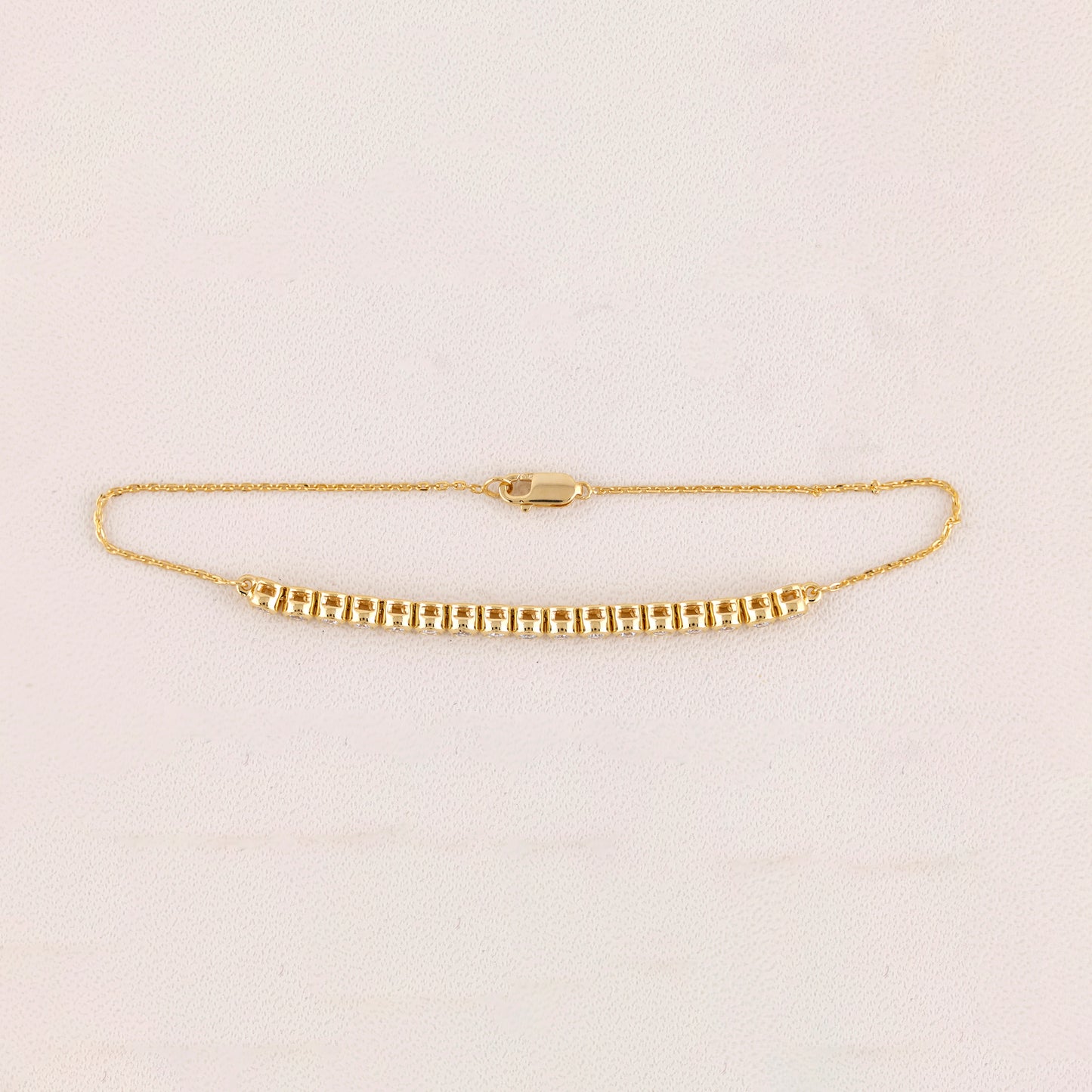Gold bracelet on a light beige background