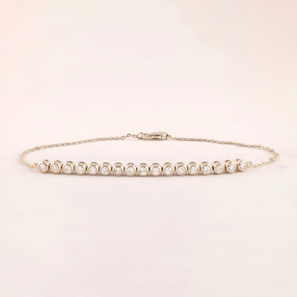 Gold bracelet with diamonds on a light beige background