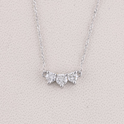 Silver necklace with a butterfly-shaped pendant on a light gray background