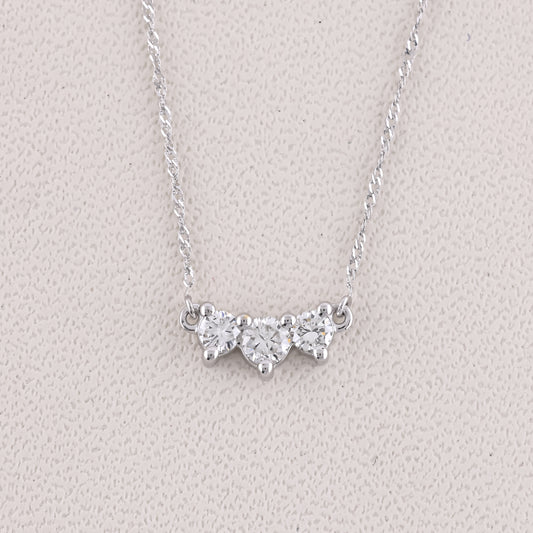 Silver necklace with a butterfly-shaped pendant on a light gray background