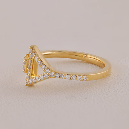 Gold ring with diamond accents on a beige background