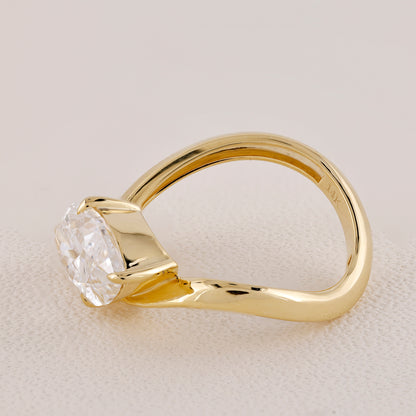 Gold ring with a diamond on a light beige background