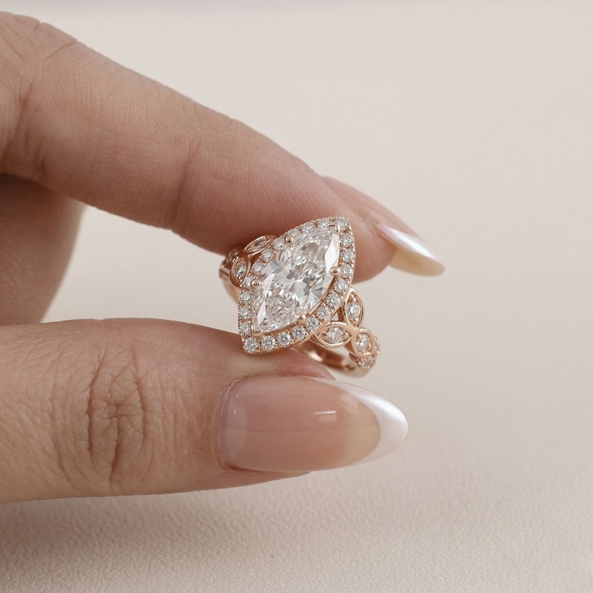 Rose gold ring with a large diamond on a neutral background