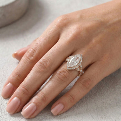 Hand wearing a diamond ring on a light background