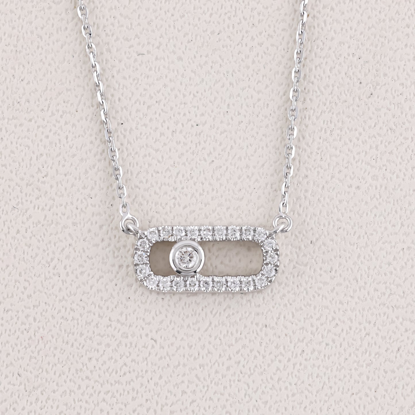 Silver necklace with a pendant on a light gray background