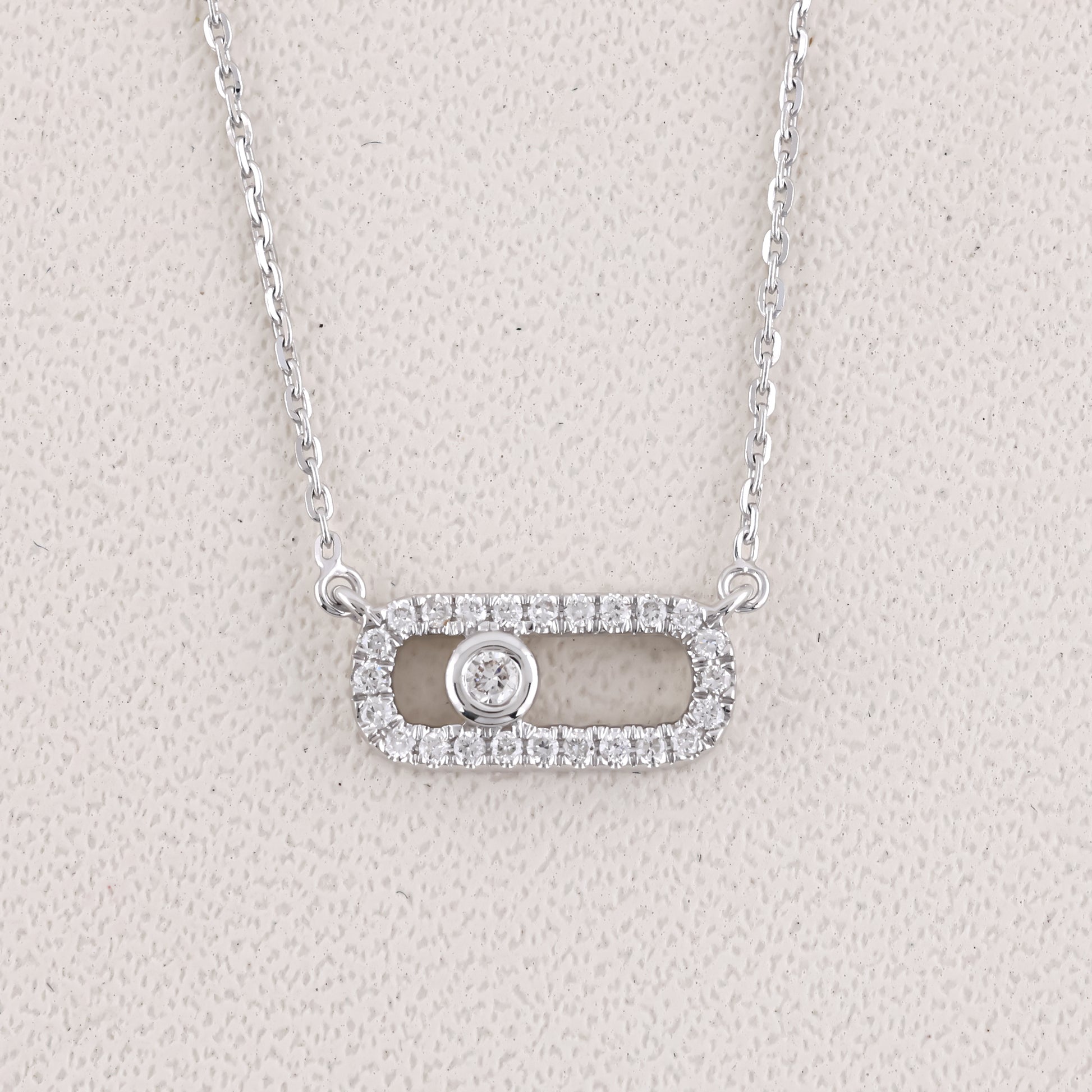 Silver necklace with a pendant on a light gray background