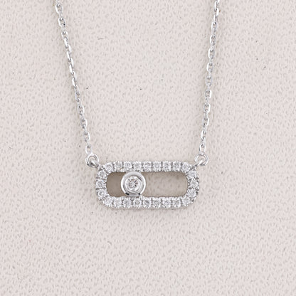 Silver necklace with a pendant on a light gray background