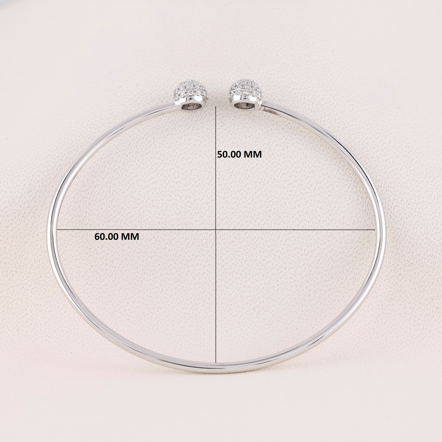 Silver necklace with measurement labels on a light background