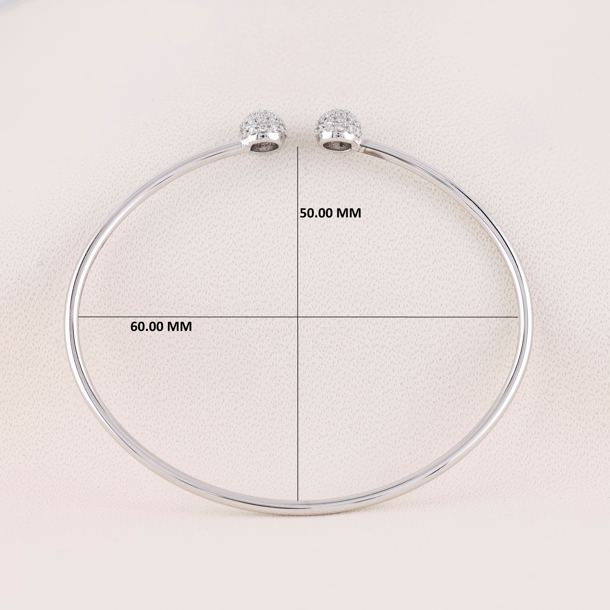 Silver necklace with measurement labels on a light background