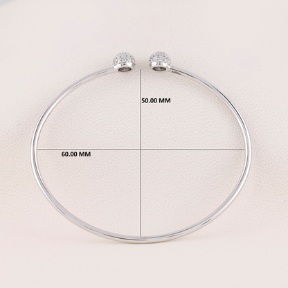Silver necklace with measurement labels on a light background