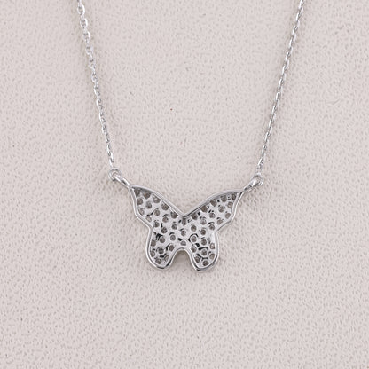 Silver butterfly necklace on a light gray background