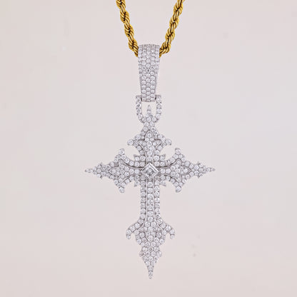Diamond-studded cross pendant on a gold chain against a light gray background