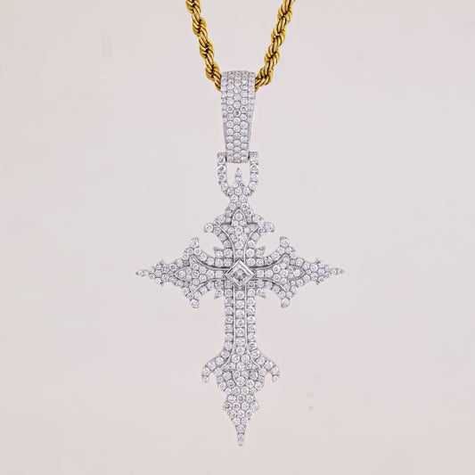Diamond-studded cross pendant on a gold chain against a light gray background