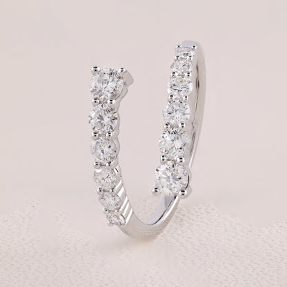 Silver hoop earring with clear gemstones on a light gray background
