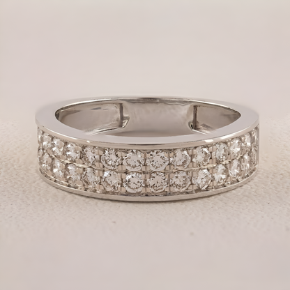 Silver ring with diamond accents on a light gray background