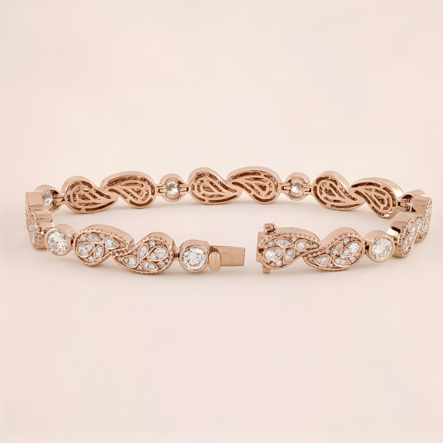 Rose gold bracelet with intricate design and clear stones on a beige background