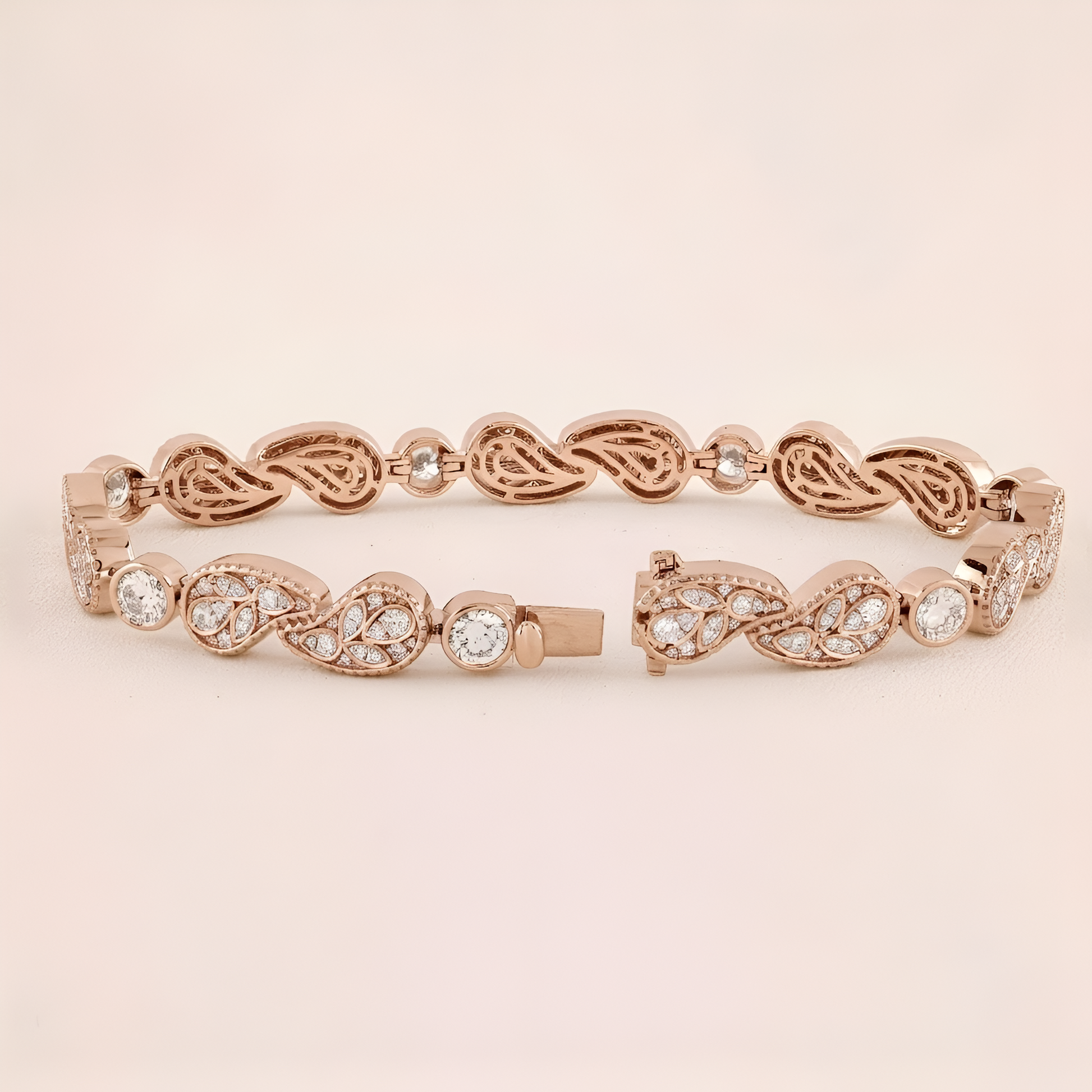 Rose gold bracelet with intricate design and clear stones on a beige background