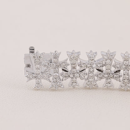 Silver bracelet with star-shaped charms on a light beige background